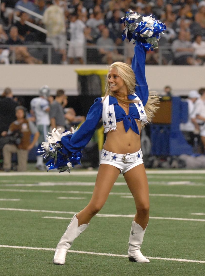 Blonde Cheerleader wearing 10 Denier Tan Sheer Nylon Tights, White Boots and Shorts